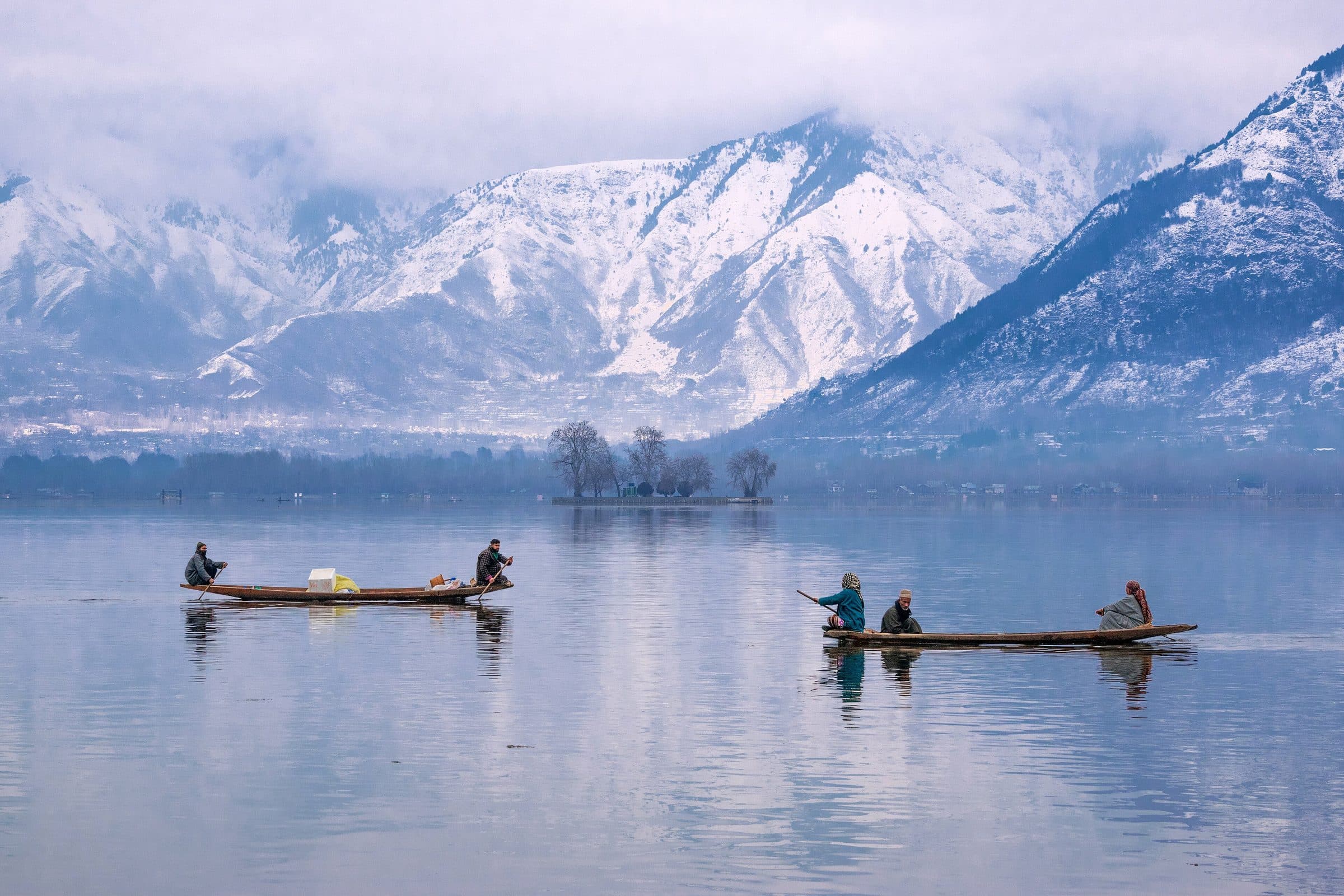 Shikaras on Dal Lake below snow-covered mountains